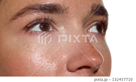 Female face macro with radiant skin and brows in bright light 132457710