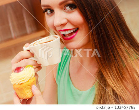 Woman drinking coffee and eating delicious cake. Woman drinking coffee and eating delicious cake. 132457768