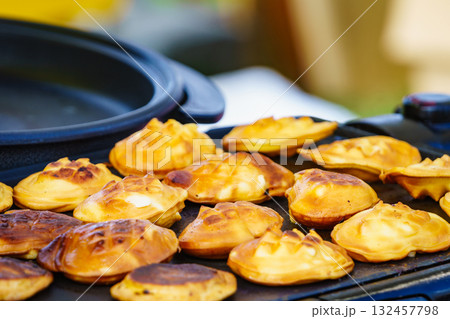 Pieces of cheese on grill 132457798