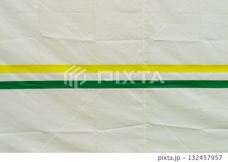 white background with green and yellow stripes. 132457957