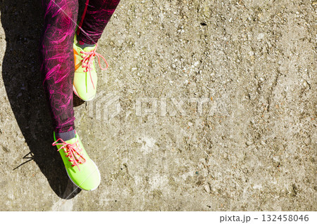Female legs feet in vivid color yellow shoes on seaside. Female legs feet in vivid color yellow shoes on seaside. 132458046
