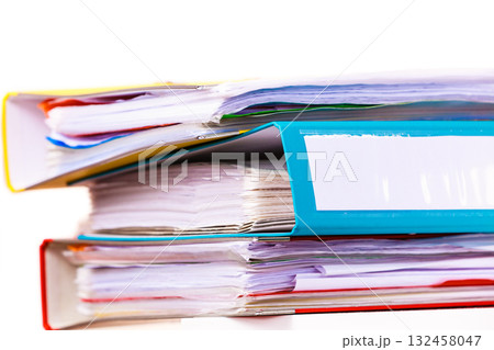 Many file folders, ring binders on office table Many file folders, ring binders on office table 132458047