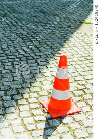White and oranger traffic cone on street White and oranger traffic cone on street 132458240