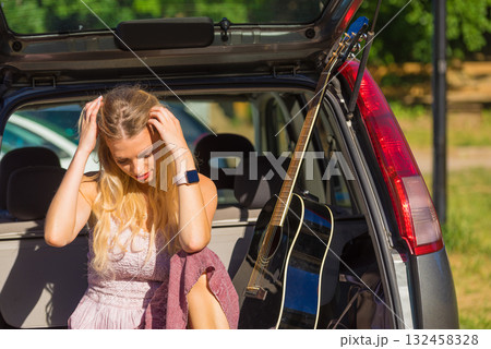 Hippie woman with guitar in van car Hippie woman with guitar in van car 132458328