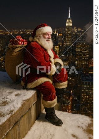 Santa sitting on snowy rooftop overlooking city skyline 132458417