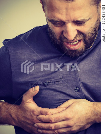 Man having heart pain attack Man having heart pain attack 132458481