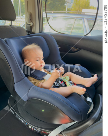 Baby in Car Seat Playing with Toy 132458709