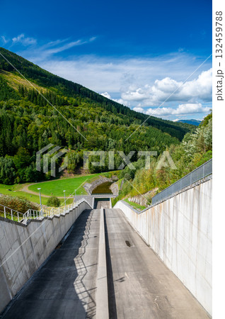 Panoramic view of the Sance reservoir and lake in summer, surrounded by green forests and blue sky, located near the Beskydy mountains in the Czech Republic. Panoramic view of the Sance reservoir and lake in summer, surrounded by green forests and blue sky, located near the Beskydy mountains in the Czech Republic. 132459788
