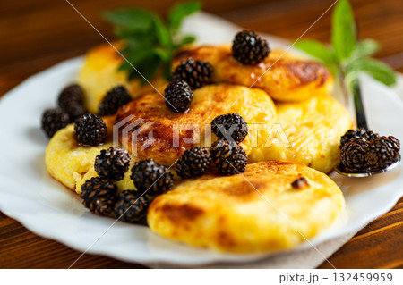 Golden cottage cheese fritters with sweet pine cone jam 132459959