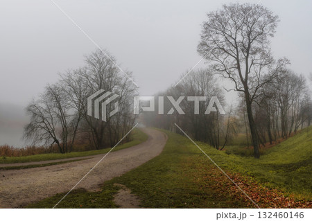 Countryside dirt road in the fog. Countryside dirt road in the fog. 132460146