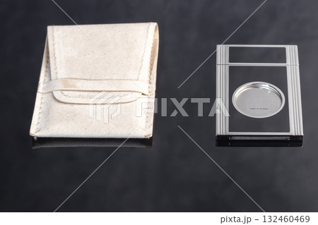 A gray metal guillotine with a sharp cigar cutter on a dark background. A gray metal guillotine with a sharp cigar cutter on a dark background. 132460469