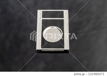 A gray metal guillotine with a sharp cigar cutter on a dark background. A gray metal guillotine with a sharp cigar cutter on a dark background. 132460471