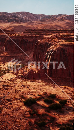 An expansive view of the Nevada desert stretching towards towering mountains in the background. 132460546