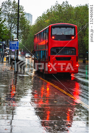 Red double-decker bus on a rainy street in London 132460661