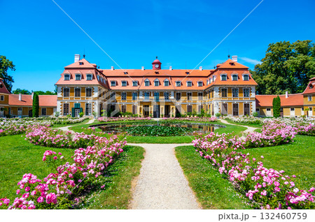 Panoramic view of Rajec Jestrebi Chateau on a sunny summer day with blue sky, blooming pink roses, and a fountain in front of the historical building. Panoramic view of Rajec Jestrebi Chateau on a sunny summer day with blue sky, blooming pink roses, and a fountain in front of the historical building. 132460759
