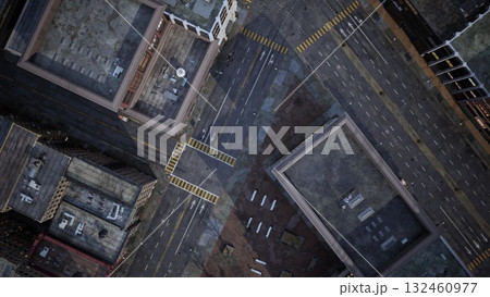 Aerial view of a bustling city intersection filled with vehicles and pedestrians. Streets are lined with buildings, showcasing the dynamic atmosphere of urban living during daylight. 132460977