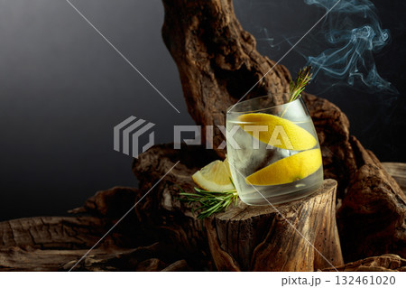 Cocktail gin and tonic with lemon slices and sprig of rosemary. 132461020