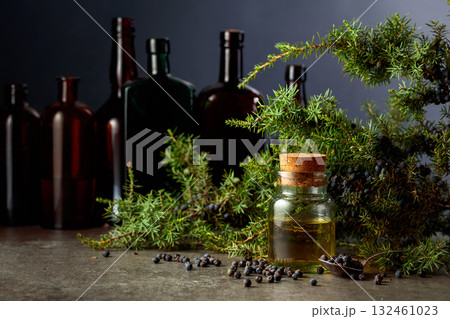 Juniper berry essential oil and branches with fresh berries. 132461023
