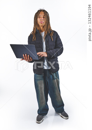 Young man with dreadlocks working on laptop Young man with dreadlocks working on laptop 132461194