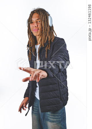 Black man with dreadlocks listening music on headphones 132461198