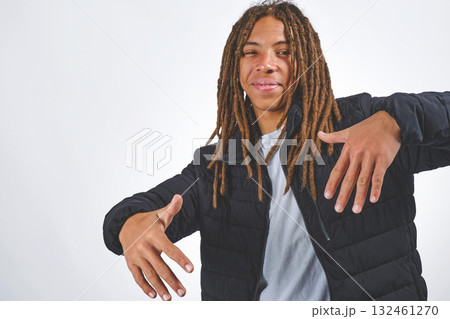 Young man with dreadlocks reaching out smiling 132461270