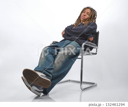 Casual teenage boy with dreadlocks looking bored Casual teenage boy with dreadlocks looking bored 132461294