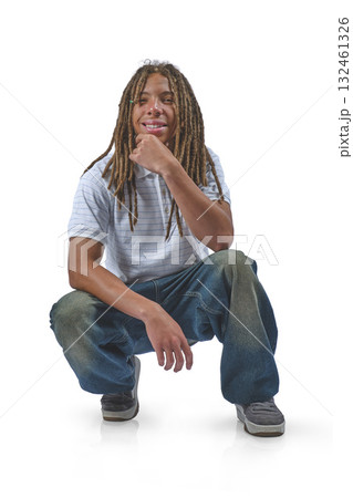Young man with dreadlocks crouching, thinking on white Young man with dreadlocks crouching, thinking on white 132461326