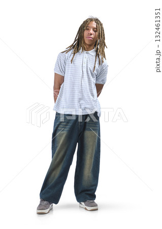Young man with dreadlocks standing looking at camera 132461351