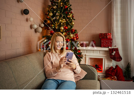 Joyful holiday moments shared through a smartphone by a woman on Joyful holiday moments shared through a smartphone by a woman on 132461518