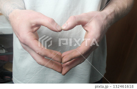 Men's hands are folded in a heart. Heart Symbol 132461618