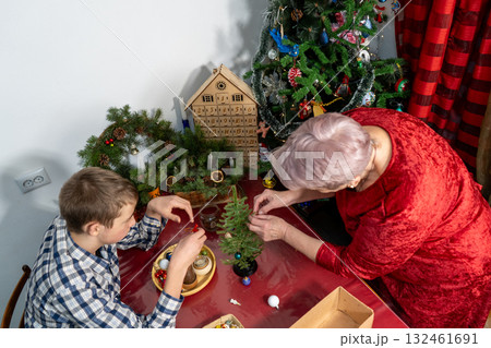 Grandmother and Grandson Decorating Christmas tree. Family together. Senior woman craft Grandmother and Grandson Decorating Christmas tree. Family together. Senior woman craft 132461691