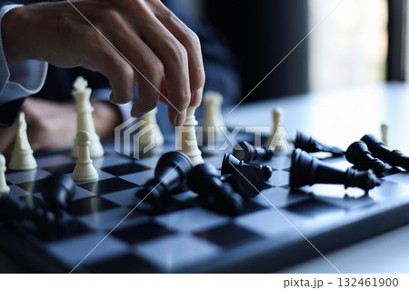Businessman wearing suit, playing chess, game, Business strategy, leadership and management concept. 132461900