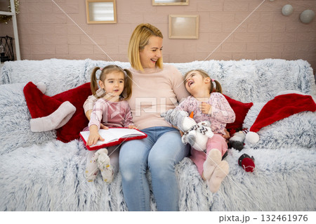 Happy family enjoying Christmas time together at home Happy family enjoying Christmas time together at home 132461976