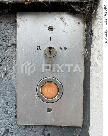 Silver button with a keyhole and the word "Halt" on it Silver button with a keyhole and the word "Halt" on it 132462094