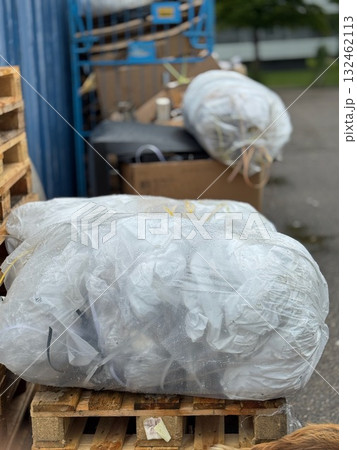 Pile of garbage bags sits on a wooden pallet 132462113
