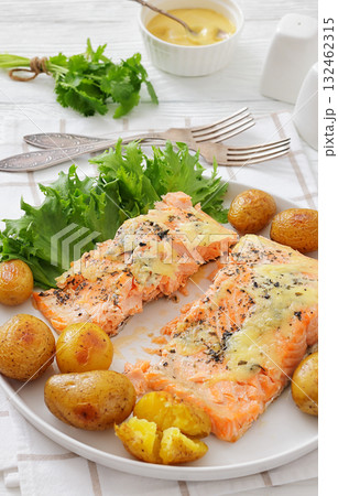 Salmon fillet with cheese, spices, baby potatoes 132462315