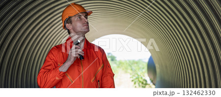 ndustry Engineers Walking Inside Circular water Pipe. Engineering or Worker inspection pipe  132462330