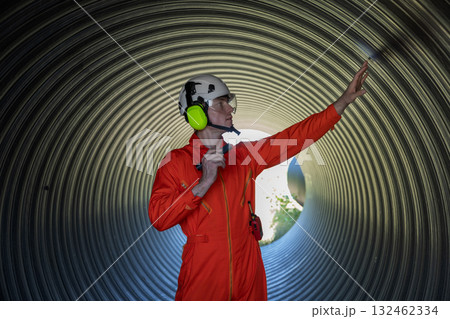 ndustry Engineers Walking Inside Circular water Pipe. Engineering or Worker inspection pipe  132462334