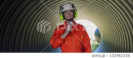 ndustry Engineers Walking Inside Circular water Pipe. Engineering or Worker inspection pipe  132462338