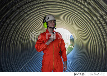 ndustry Engineers Walking Inside Circular water Pipe. Engineering or Worker inspection pipe  132462339