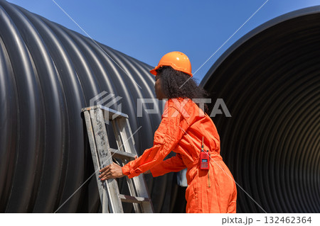 ndustry Engineers Walking Inside Circular water Pipe. Engineering or Worker inspection pipe  132462364