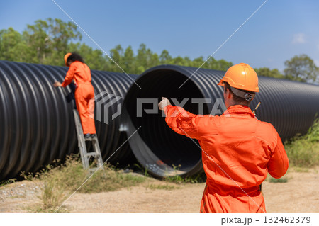 ndustry Engineers Walking Inside Circular water Pipe. Engineering or Worker inspection pipe ndustry Engineers Walking Inside Circular water Pipe. Engineering or Worker inspection pipe 132462379