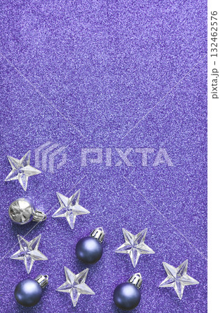 Purple New Year's Christmas background with baubles and stars. Top view, space for text. 132462576