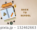 Open notebook with pencils, pens, ruler, compass and eraser on beige background back to school 132462663