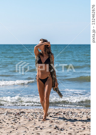 Beachwear confident woman, Sunlit seaside woman in style, Casual summer fashion with bright sunlight and ocean waves 132462676