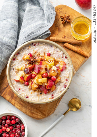 Overnight oatmeal with apple, honey, cranberry and cinnamon in a plate on a marble background 132462847