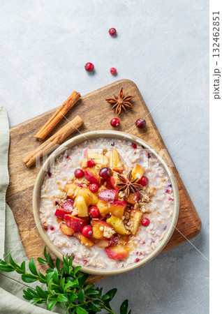 Overnight oatmeal with apple, cranberry and cinnamon in a plate on a light background Overnight oatmeal with apple, cranberry and cinnamon in a plate on a light background 132462851