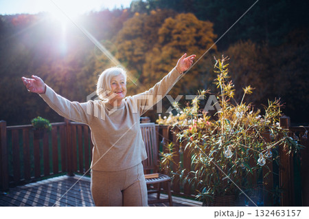 Senior woman enjoying warm autumn sun. Senior woman enjoying warm autumn sun. 132463157