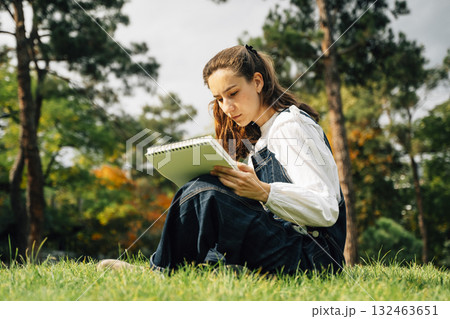 Girl Drawing in Summer Park. Relax lifestyle portrait Girl Drawing in Summer Park. Relax lifestyle portrait 132463651