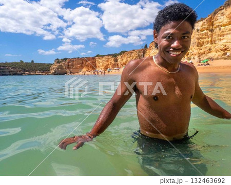 Young African American man swims in ocean in Algarve Portugal Sra da Rocha Beach Young African American man swims in ocean in Algarve Portugal Sra da Rocha Beach 132463692